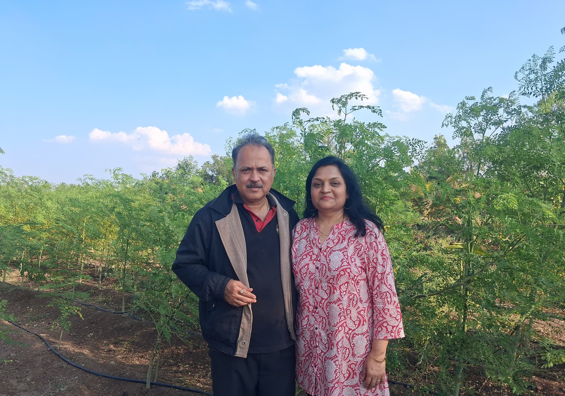 Founder standing in the moringa fields